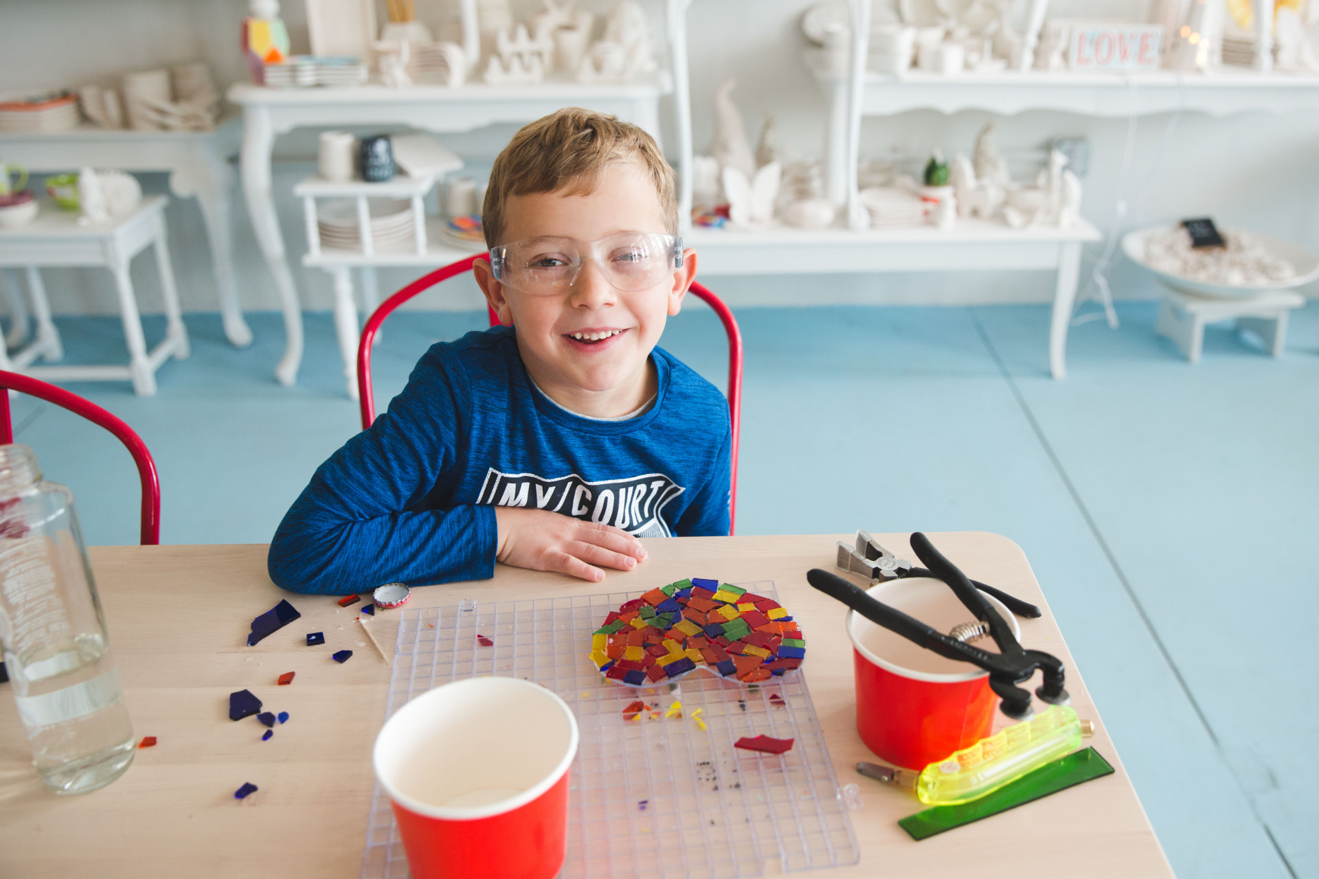 A young artist creating a colorful fused-glass mosaic
