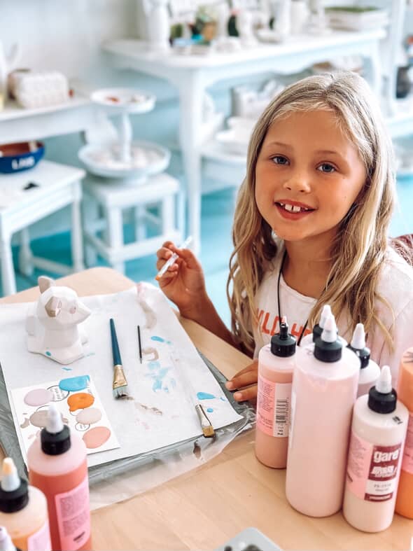 A young artist painting pottery at The Cherry on Top in Lampasas, Texas